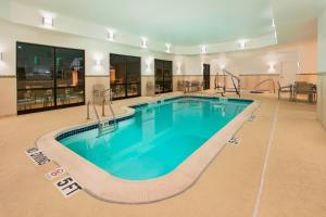 a large swimming pool in a hotel room at SpringHill Suites Mishawaka-University Area in South Bend