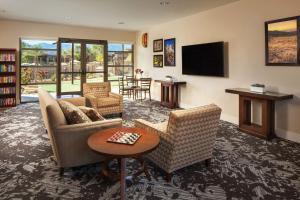 a living room with two couches and a tv at The Westin Desert Willow Villas, Palm Desert in Palm Desert
