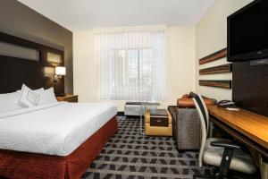 a hotel room with a bed and a desk at TownePlace Suites by Marriott San Antonio Downtown Riverwalk in San Antonio