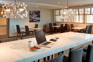 a laptop computer sitting on a table in a restaurant at Residence Inn by Marriott San Diego Chula Vista in Chula Vista