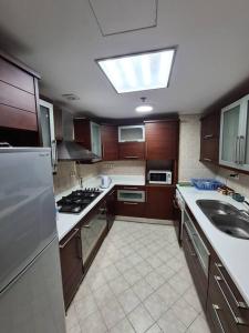 a kitchen with a sink and a stove top oven at Luxury Hotel Apartment at Grand Plaza, San Stefano with Access to fee-based facilities at Four Seasons in Alexandria