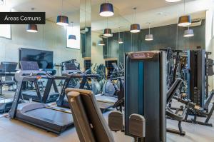 a gym with a lot of treadmills and ellipticals at House of Charlie Vila Mariana in Sao Paulo