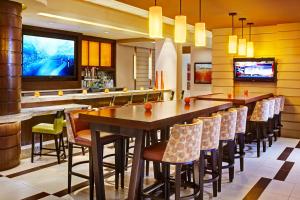 a bar with a long table and chairs in a restaurant at Scottsdale Marriott Old Town in Scottsdale