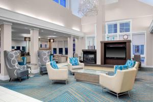 a large lobby with chairs and a fireplace at Residence Inn by Marriott Richmond Chester in Woodvale