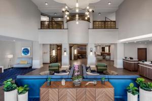 a large lobby with a blue couch and chairs at Courtyard by Marriott San Diego Miramar in San Diego