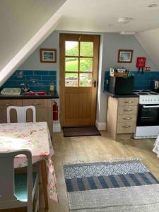 a kitchen with a sink and a stove at Barn Flat overlooking beautiful Dorset vale in Sherborne