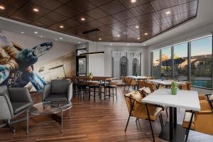 a restaurant with tables and chairs and a mural on the wall at Courtyard by Marriott San Diego Miramar in San Diego