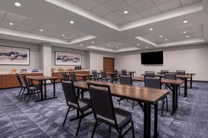 a conference room with tables and chairs and a screen at Courtyard by Marriott San Diego Miramar in San Diego
