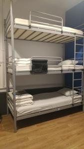 a bunk bed with white bunk beds in a room at Popcorn Hostel in Bucharest