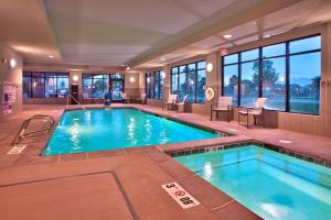 a large swimming pool in a hotel room with a large window at TownePlace Suites by Marriott Salt Lake City-West Valley in West Valley City
