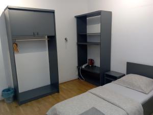 a bedroom with two beds and a black cabinet at Meier House Wawer in Warsaw