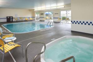 a large hot tub in a room with chairs and tables at Fairfield Inn by Marriott Port Huron in Port Huron