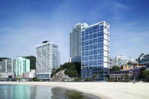 a view of a beach with buildings in the background at Fairfield by Marriott Busan Songdo Beach in Busan