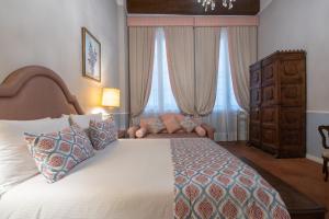 Postel nebo postele na pokoji v ubytování Dimora del Cardinale - Residenza d'Epoca