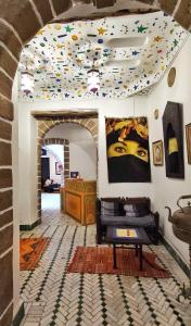 a living room with a ceiling covered in confetti at Hotel Dar El Qdima in Essaouira