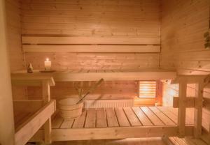 an inside of a wooden sauna with a candle at Golden Port SPA - Easy-Rent Apartments in Dziwnów