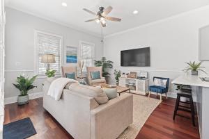 a living room with a couch and a flat screen tv at Private Rooftop & Parking - 3 Blocks to King St in Charleston