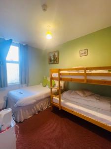 a bedroom with two bunk beds and a window at Sea Princess Hotel Blackpool in Blackpool