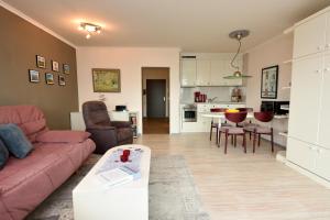 a living room with a couch and a table at Haus "Panorama" Appartement PAN069 in Duhnen