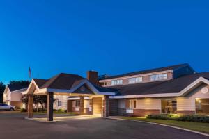 a house with a driveway in front of it at SureStay Plus Hotel by Best Western Litchfield in Litchfield