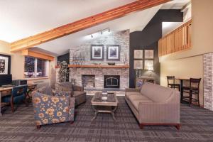 a living room with a couch and a fireplace at SureStay Plus Hotel by Best Western Litchfield in Litchfield