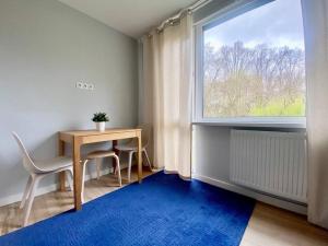 a dining room with a table and a large window at K22 Park Mokotow Aparts in Warsaw