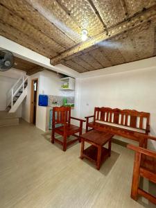 a living room with a bench and two chairs at Lorenza 2 and 3 in Buruanga +37 photos