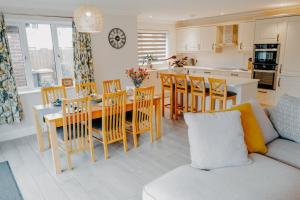a kitchen and living room with a table and chairs at Cottage in the Heart of Suffolk in Stowmarket