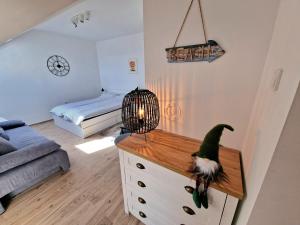a living room with a dinosaur on top of a dresser at Studio apartman Varadero in Bjelovar