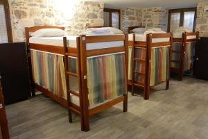 a group of four bunk beds in a room at Montenegro Hostel B&B Kotor in Kotor
