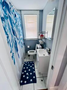 a bathroom with a white toilet and a sink at Dale first floor in Richmond Heights