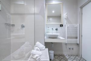 a white bathroom with a sink and a mirror at Dimora del Cardinale - Residenza d'Epoca in Florence