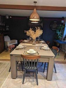 諾丁漢的住宿－Cheerful 3-bed detached home，一张带椅子的木桌和花瓶