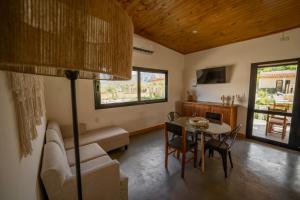 a living room with a table and a couch at Complejo Los Olivos - casa 3 y 4 in Cafayate