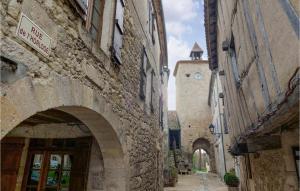 an alley with a building with a clock tower at Awesome Apartment In Maulon Darmagnac With Wifi in Mauléon-dʼArmagnac