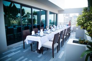 a dining room with a long table and chairs at Lakeshore Banani in Dhaka