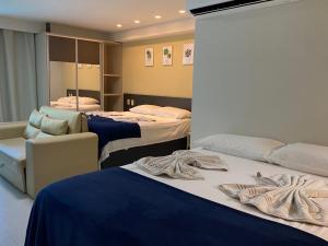 Ένα ή περισσότερα κρεβάτια σε δωμάτιο στο Tabatinga Flat - Beira Mar