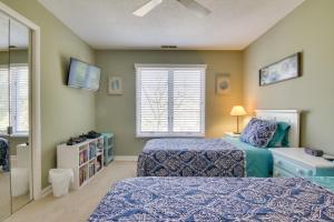 a bedroom with two beds and a window at Condo with 2 Balconies and 3 Pools Less Than 2 Mi to Beach! in Rehoboth Beach