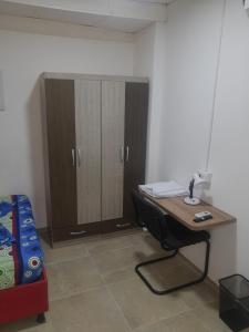 a room with a desk and a cabinet and a bed at Apartaestudio buenos aires in Barrancabermeja
