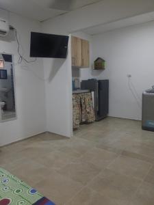 a kitchen with a refrigerator and a counter top at Apartaestudio buenos aires in Barrancabermeja
