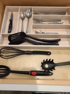 a wooden drawer with utensils in it at Chicago Exquisite Haven 2bed 2bath Near Downtown and United Center in Chicago