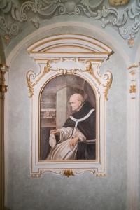 a painting of a man in a window on a wall at Dimora del Cardinale - Residenza d'Epoca in Florence
