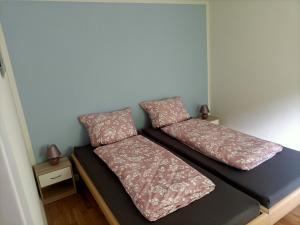 a bed with two pillows on it in a room at Papststein in Rathmannsdorf