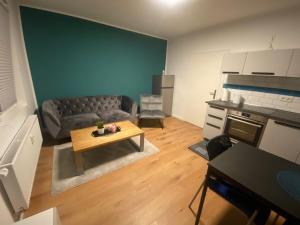 a living room with a couch and a table at 2 Zimmer Wohnung in Krefeld City/Apartment + Netflix+Prime in Krefeld