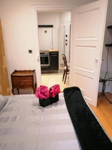 a bedroom with a bed with two bags on it at A la Tour des Rohan in Strasbourg