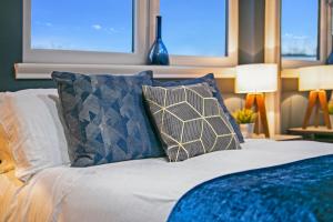 a bedroom with a bed with two pillows at Countesswells Crescent Villa ✪ Grampian Lettings Ltd in Aberdeen