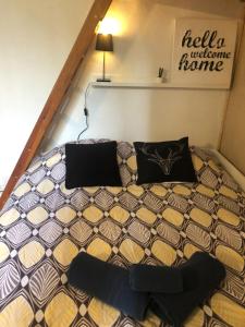 a bed in a small room with two pillows at Studio Saint merry Fontainebleau in Fontainebleau