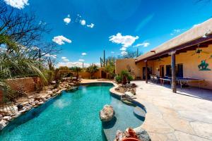 a swimming pool in a yard with a house at Saguaro Sanctuary in Tucson