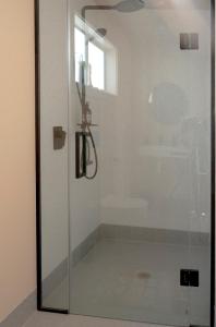 a shower with a glass door in a bathroom at The Castle in Greytown