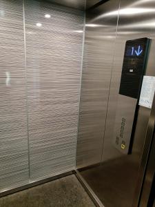 a metal elevator in a building with a sign on it at C&C Mamaia Studio in Mamaia